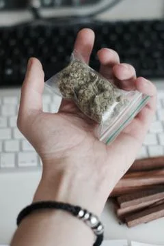 Bag with a marijuana in hand Stock Photos