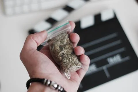 Bag with a marijuana in hand Stock Photos