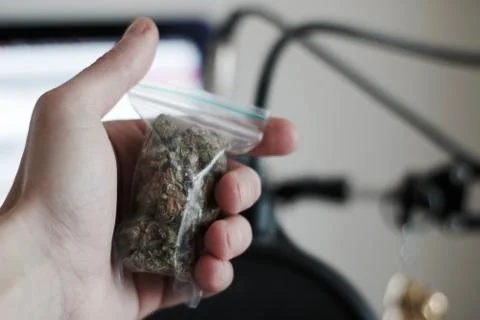 Bag with a marijuana in hand Stock Photos