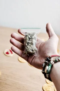 Bag with a marijuana in hand Stock Photos