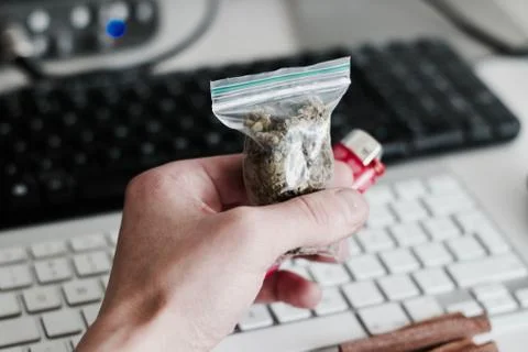 Bag with a marijuana in hand Stock Photos