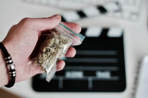 Bag with a marijuana in hand Stock Photos