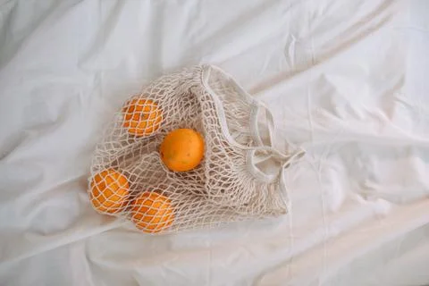A bag with oranges on a bed Stock Photos