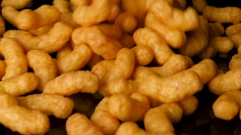 A bag of peanut flips is emptied on a black reflective background. Stock Footage 151883415