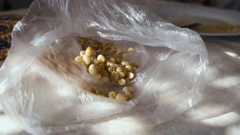 Bag of raw peanuts on a table Stock Footage 146307310