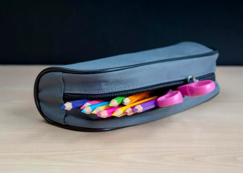 Bag with school tools on a blackboard background. Stock Photos