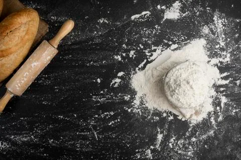 Bag of wheat flour, rollers and white powder spread on the table, there is a  Stock Photos