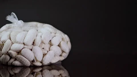 A bag of white beans made of thin nylon lines thrown and landing on a refle.. Stock Footage 263896199