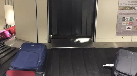 Bagagge falling onto carousel Stock Footage 44860675