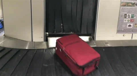 Bagagge falling onto carousel Stock Footage 44860787