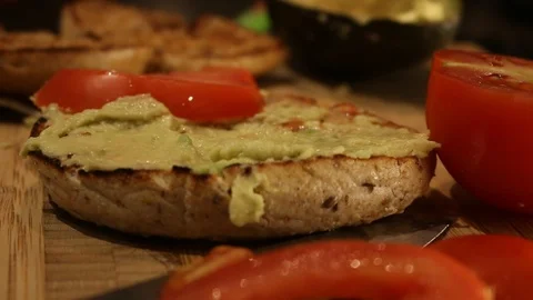 Bagel Avocado Tomato Hand Stock Footage 126665992