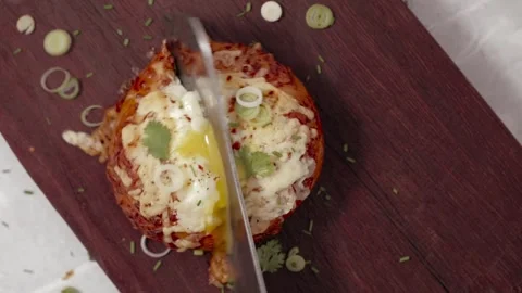 Bagel with Baked Egg Being Cut in Half Stock Footage 245137200