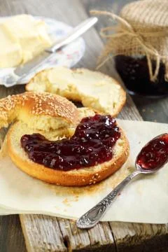 Bagel with jam and butter. Stock Photos