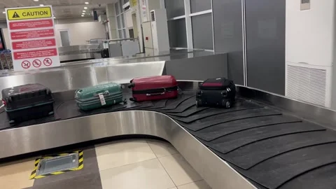 A baggage carousel at an airport with suitcases Stock Footage 337242191