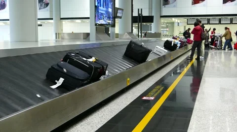 Baggage carousel, man quickly take small backpack from conveyor tape Stock Footage 49847072