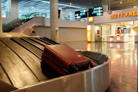 Baggage claim area with empty baggage strap at the airport. Suitcase on luggage Fotos Stock