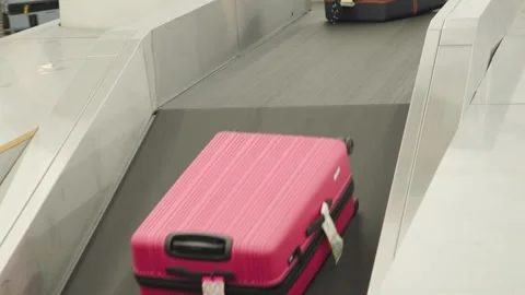 Baggage claim process at airport on conveyor belt Stock Footage 339323579