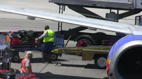Baggage  Handlers Loading Plane Stock Footage 26311919