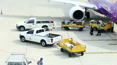 Baggage Handlers Working By a Plane 스톡 동영상 29876500