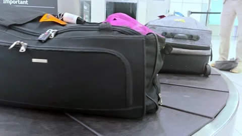Baggage on a moving conveyor carousel system Stock Footage 332057265