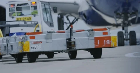 Baggage Tug and Dollies pulling away Stock Footage 114033098