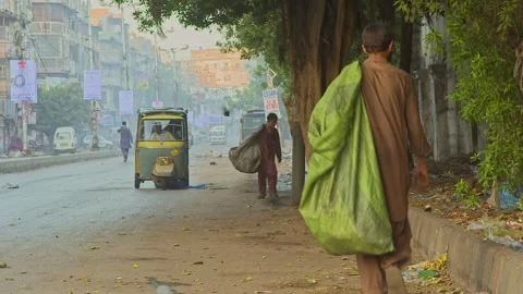 Bagger man crosses the road some where in Pakistan 6th Feb 2020 Editorial Stock 動画素材 256988020