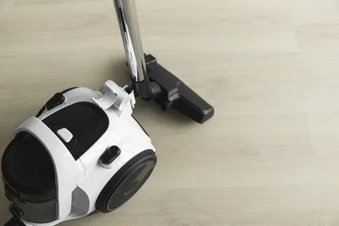 Bagless cyclone vacuum cleaner on a laminate. Electrical apparatus that by means Stock Photos