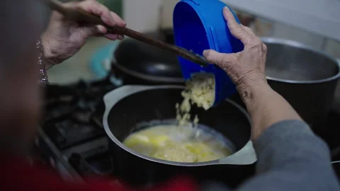 Bagna cauda cooking with basic ingredients by an elderly person of boiling Video stock 313264863