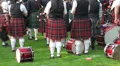 Bagpipe band drummers in kilts waiting at Highland Gathering HD Footage