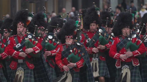 Bagpipe players walking marching at St. Patrick's day parade slow motion Stock Footage 236241573