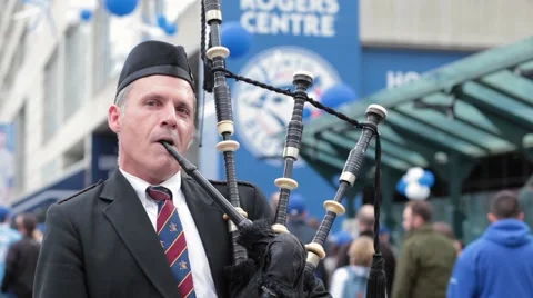Bagpipes player outside rogers centre close up face Stock Footage 56019883