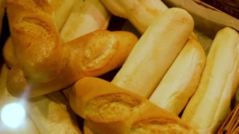 Baguettes lying in a wicker basket close-up under the glass of the display case Stock Footage 315022944