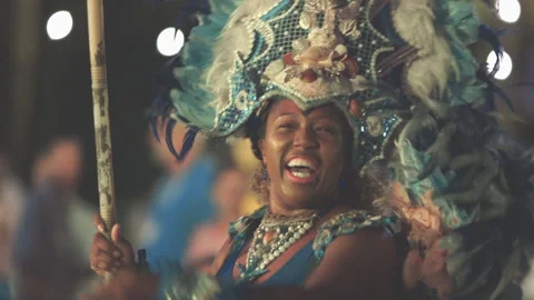 Bahamas Junkanoo Dancer performs and waves Bahamian flag during celebration Stock Footage 281296911
