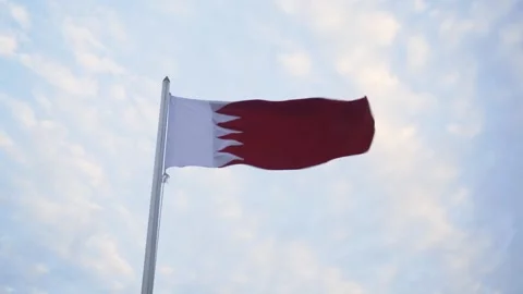 The Bahrain flag in the breeze under a blue sky Stock Footage 245226633