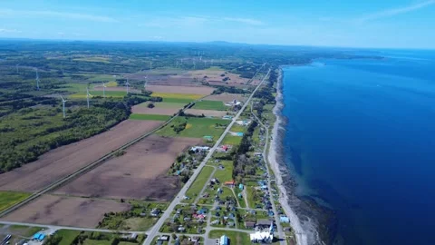 Baie-des-Sables surrounded by the St. Lawrence Estuary and wind turbines. Stock Footage 341271041