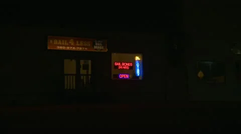 Bail bonds neon sign night and 24 hr notary, zoom in Stock Footage