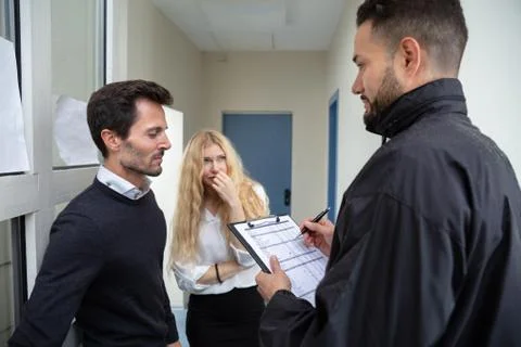 Bailiff Talking With Sad Couple Stock Photos