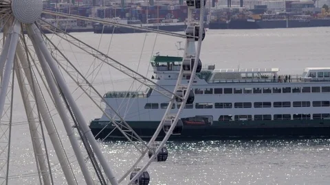 Bainbridge ferry headed into seattle port with ferris wheel Stock Footage 83321490