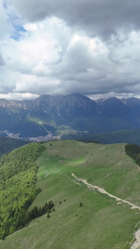 Baiu Mountains ridge trail with Bucegi panorama aerial spring Romania Stock Footage 335071957