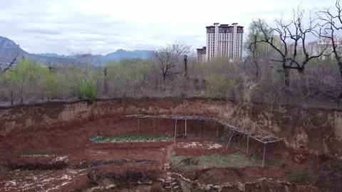 The Baiyun Building rises from the pit Stock Footage 247363282