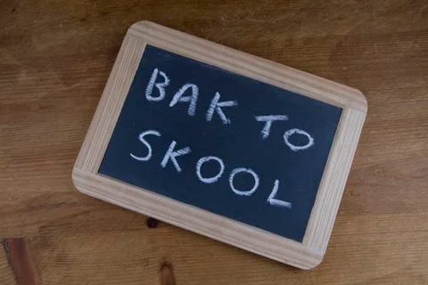 Bak to skool, back to school written on replica old blackboard writing slate Stock Photos