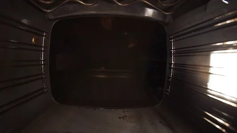 Bake the bread in the oven. Close-up, a guy with a tray. Stock Footage 99632096