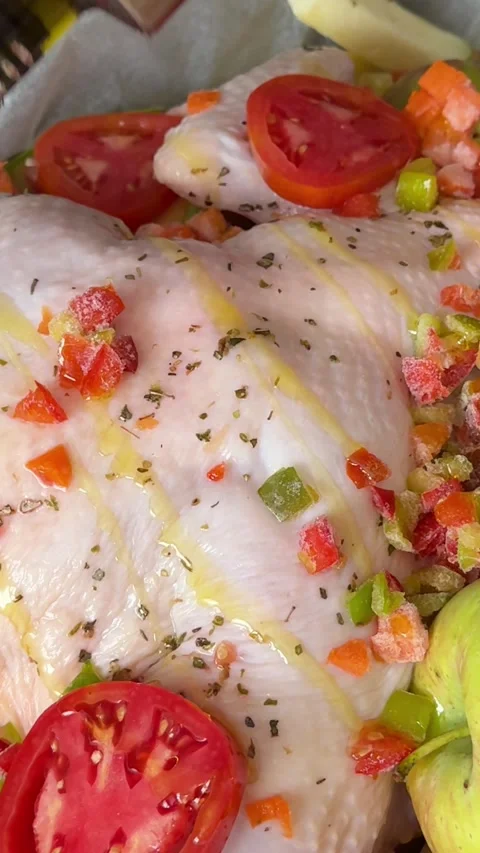 Bake chicken pour olive oil on a baking sheet whole chicken carcass tomatoes Stock Footage 317094466