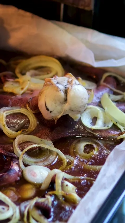 Bake octopus in the oven Baked assorted seafood cuisine of Mixed fish fillet Stock Footage 302176719