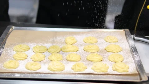 Bake profiteroles pastry chef makes eclairs in a bakery. eclairs are baked in Stock Footage 281065401