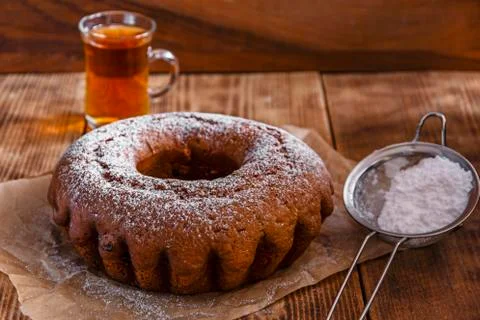 Bake ring cake with icing sugar and raisins Stock Photos