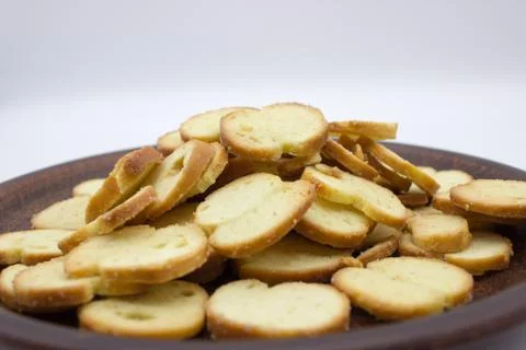 Bake Rolls. The mini bread chips on the brown bowl. Isolated on white backgro Stock Photos