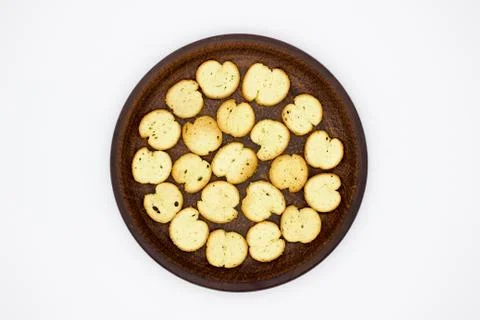 Bake Rolls. The mini bread chips on the brown bowl. Isolated on white backgro Stock Photos