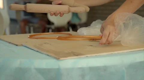 Bake rolls out the dough on a silicone mat sprinkled with flour Stock Footage 68499145