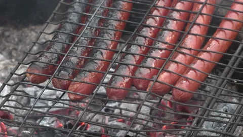 Bake sausages on the fire Stock Footage 142347906